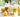 Homemade Limoncello bottles with lemons around and small drinking glasses